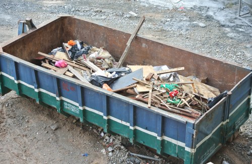 Construction workers managing waste on a Brixton site